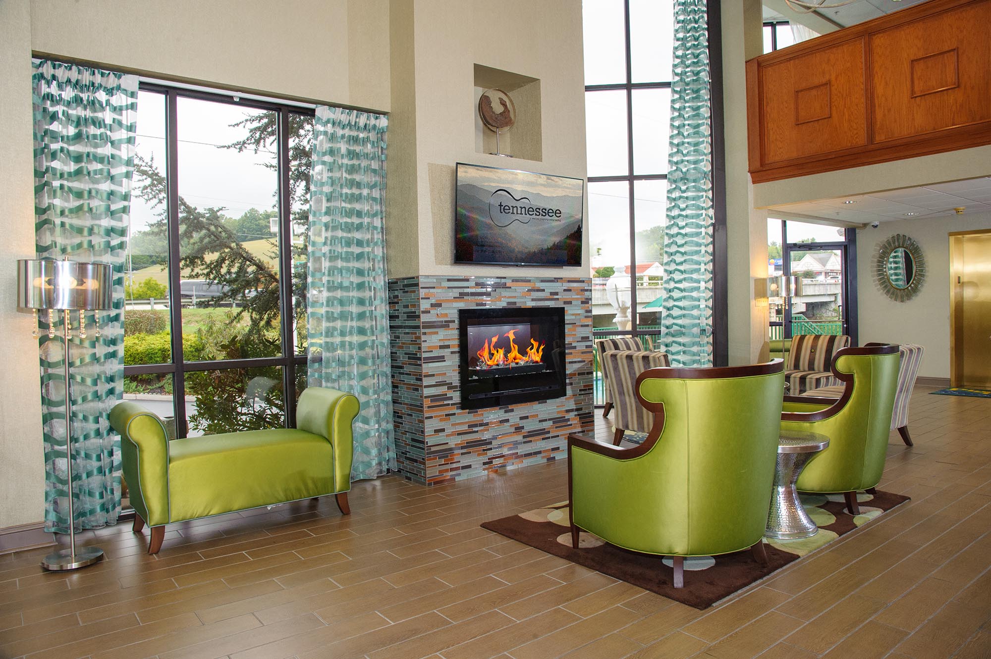 Green chairs to watch fire place and Television