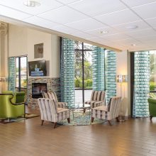 Lobby view of Hotel with green chairs to meet guests